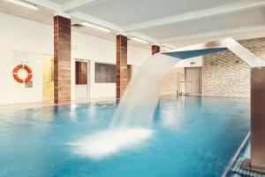 a water fountain in a swimming pool at Apartamenty Every Sky Polna 4 Karpacz in Karpacz