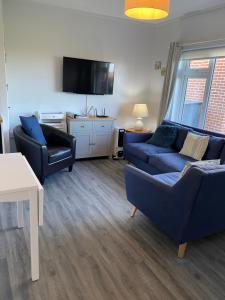a living room with two couches and a tv at Seafields Chalet in Walcott