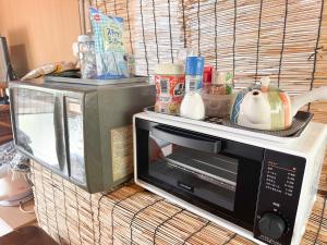 a microwave oven sitting on top of a table at 民泊Toshi29 in Wadomari