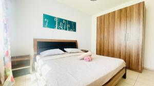 a bedroom with two beds and a wooden cabinet at Sea Bliss Villa1 in Pereybere +4 photos