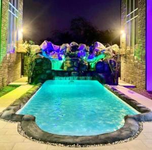 a swimming pool in the backyard of a house at night at Sea Bliss Villa1 in Pereybere