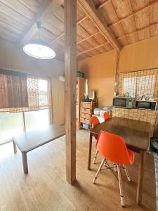 a dining room with a table and a chair at 民泊Toshi29 in Wadomari