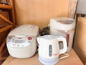 two machines sitting on a shelf next to a toilet at 民泊Toshi29 in Wadomari