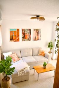 a living room with a couch and a table at Casa Jema - Family house with ocean views in Gran Alacant