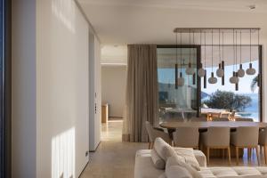 a living room with a couch and a table at Villa On the Rocks in Finikounta