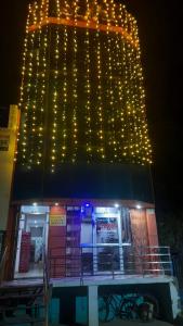 a building with christmas lights on top of it at Hotel Rajganga in Gonda