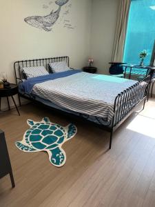 a bedroom with a bed with a turtle rug on the floor at Gwangalli #Modern #Korea in Busan +19 photos