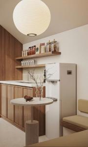 a kitchen with a table and a refrigerator at Moon Inn Apartment-self check in in Hanoi