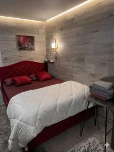 a bedroom with a large bed with a red headboard at Main Street House in Chişinău