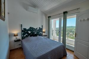 a bedroom with a bed and a large window at Villa 259 in Roquebrune-sur-Argens +44 photos