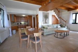 a living room with a table and a couch at Lefkada Sunset Villa in Kalamitsi