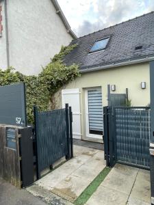 a black gate in front of a house at Appartement proche Zenith & Polyclinique in Nantes
