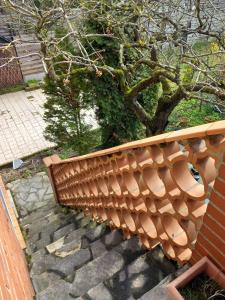 a wooden staircase with a wooden railing next to a tree at Coquette maison in Dunkerque
