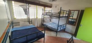 a room with two bunk beds and a mirror at Uhuru Peak Hostel in Moshi