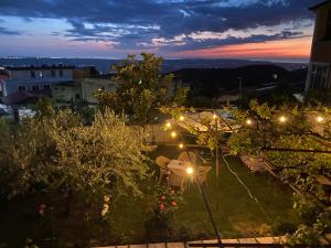 a view of a garden at night with lights at Vila Llulla in Krujë