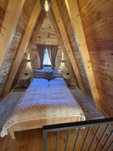a bed in the attic of a log cabin at Villa Silence in Žabljak