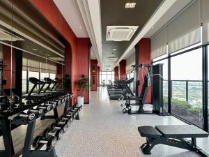 a gym with a row of treadmills and machines at Xim Condo in Bangkok 20 mins to Asiantique in Ban Tha Hin