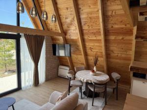 a room with a table and chairs and a tv at Villa Silence in Žabljak