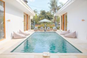 a swimming pool in the middle of a house at Dolphin - New luxury rooms in Lovina Centre & near the beach in Lovina
