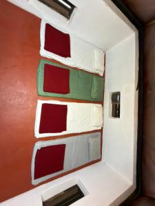 a room with red and green windows on the wall at Aravanazhi tharavadu in Thirunelli