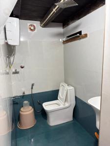 a small bathroom with a toilet and a sink at Aravanazhi tharavadu in Thirunelli