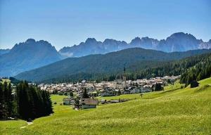 a town in a valley with mountains in the background at Mansardina Il Nido in Padola