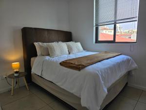 a bedroom with a large bed with a window at Prestige stays in Windhoek