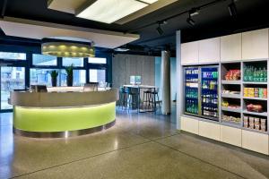 a bar in a restaurant with a drink counter at Aloft by Marriott Stuttgart in Stuttgart
