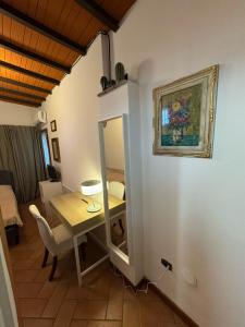 a dining room with a table and a mirror at Villa il Lauro in Pisa