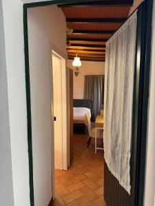 a hallway with a room with a bed and a table at Villa il Lauro in Pisa