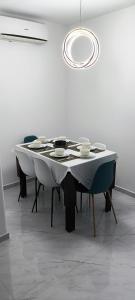 a table with bowls and plates on it in a room at Magnifique appartement de trois chambres, Résidence Kabila Vista in M'diq +73 photos