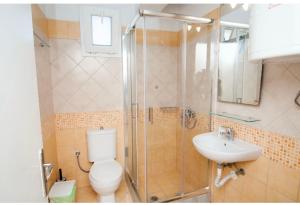 a bathroom with a shower and a toilet and a sink at Ypsipyli in Myrina +36 photos