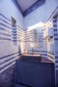 a bathroom with a sink and a mirror at Le Clarisse Guest House in Pondicherry +37 photos