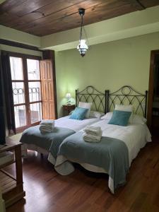a bedroom with two beds with towels on them at La Carbonería in Béjar
