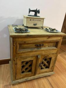 a wooden table with a sewing machine on top of it at La Carbonería in Béjar