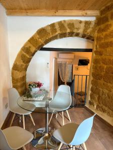 a dining room with a glass table and chairs at 58 Gradini di Girgenti in Agrigento +45 photos