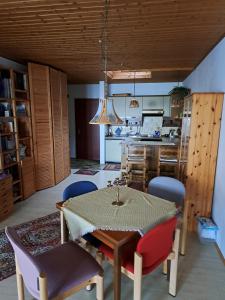 a kitchen and dining room with a table and chairs at Wasgau Urlaubserlebnis Fels und Seen in Ludwigswinkel +18 photos
