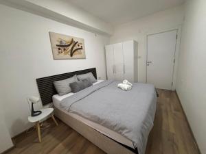 a bedroom with a large bed and a chair at M&M Cozy Apartment-Free Parking in Skopje