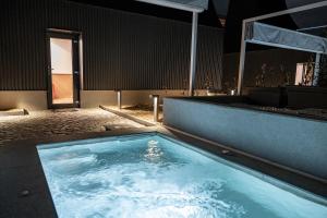 a large pool of water in a room at Three Peaks Thermal Villas in Banya