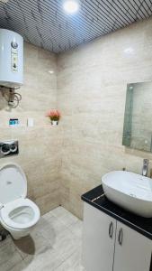 a bathroom with a toilet and a sink at Elevenstay in Ghaziabad