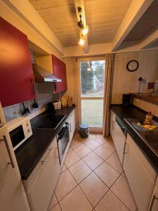 a kitchen with black counter tops and a window at Ferienhaus Baabe in Baabe