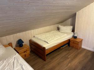 a small room with a bed and two night stands at Ferienhaus Baabe in Baabe