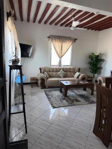 a living room with a couch and a coffee table at Munaa House Wiyoni in Lamu