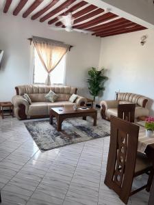 a living room with a couch and a table at Munaa House Wiyoni in Lamu