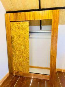 a room with a wooden cabinet with yellow stuff at Phayam Paradise Resort in Ko Phayam