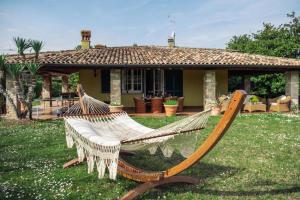 a hammock in a yard in front of a house at Villa Mary in Montinelle