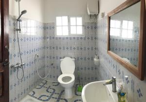 a bathroom with a toilet and a sink at House on the beach in Jambiani