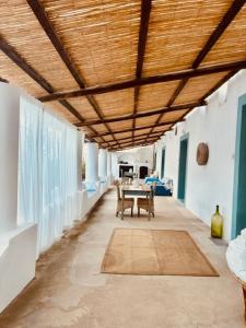 a hallway with a table and a wooden ceiling at Dépendance Liscio in Filicudi