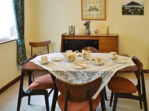 a dining room table with a table cloth on it at The Gazebo in Marazion