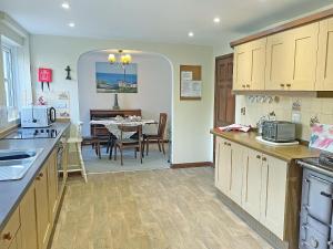 a kitchen with a table and a dining room at The Gazebo in Marazion +6 photos